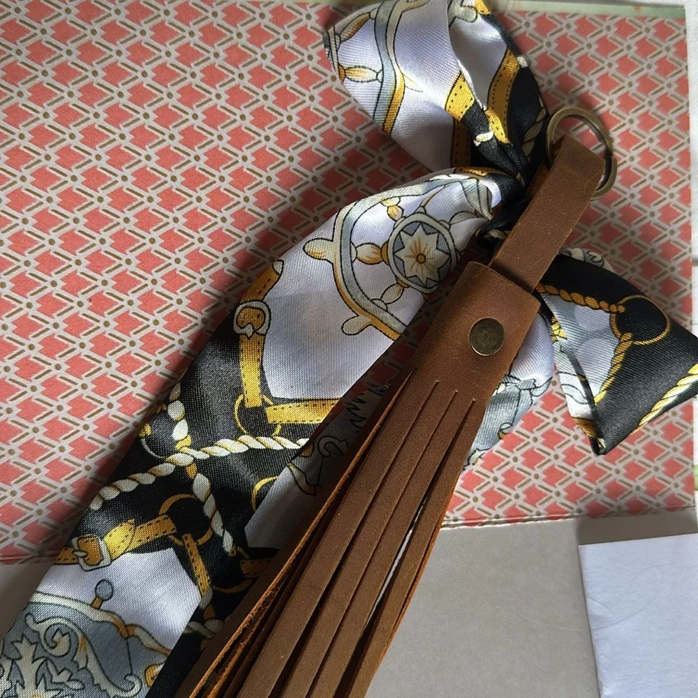 Brown TASSEL KEYCHAIN/bag charm with detachable scarf.